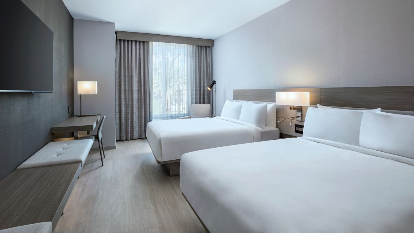 two queen beds, desk, TV, lighting, - AC Hotel Las Vegas Symphony Park Guest Rooms Deluxe Double Queen