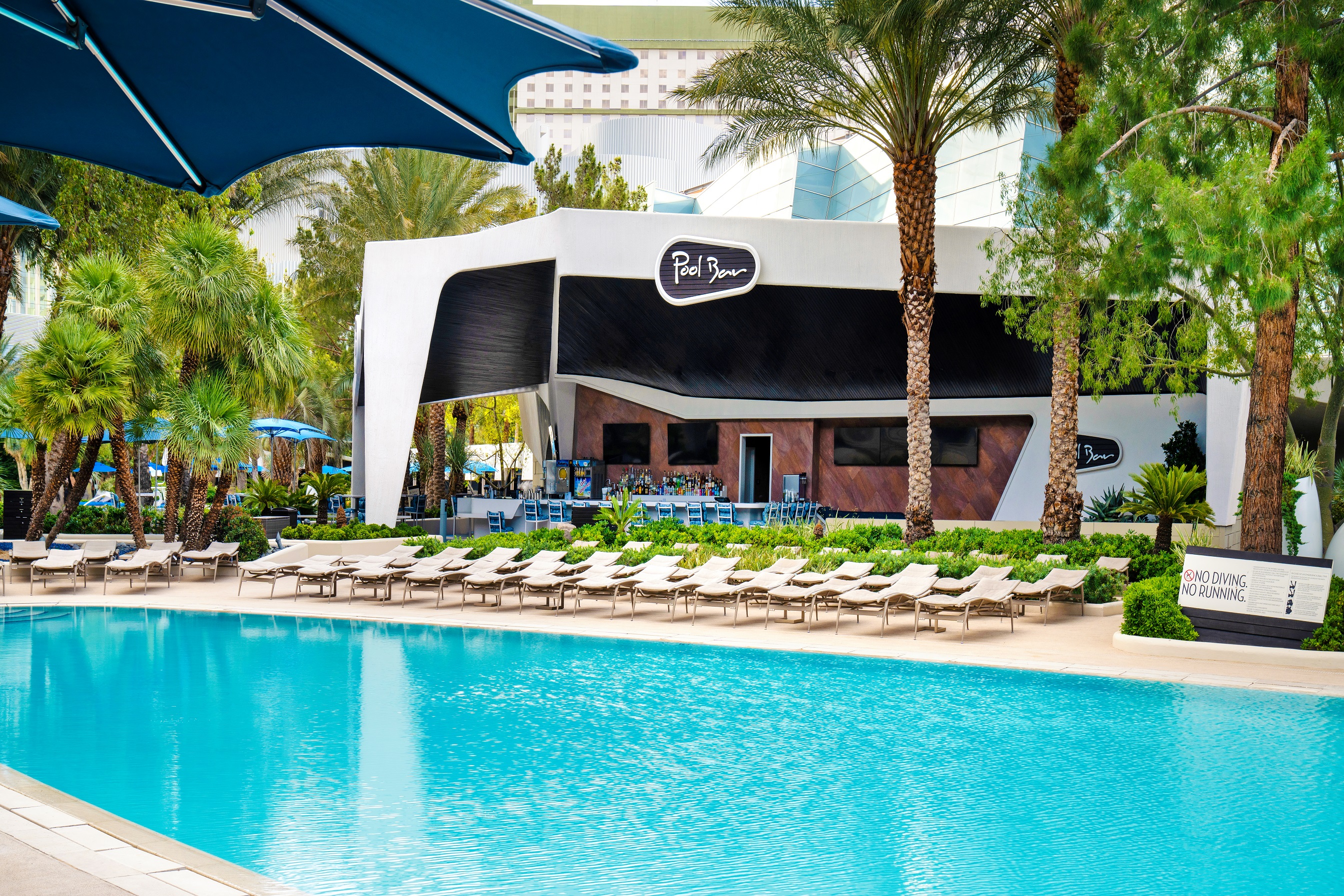 ARIA pool and pool bar surrounded by palm trees