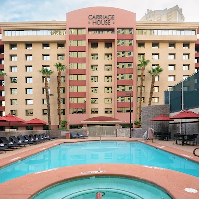 Carriage House Deluxe Suite Hotel official pool and property exterior