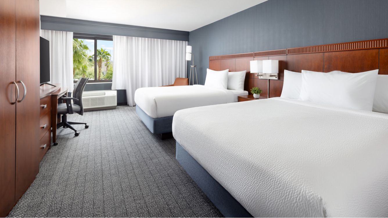 Two Queen Beds Guest Room with chair and desk - Courtyard by Marriott Las Vegas Stadium Area Guest Rooms Two Queen Beds Guest Room