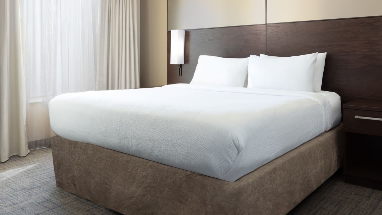 king-size bed, plush linens, and natural lighting - Residence Inn by Marriott Las Vegas Airport Suites Spacious Corner Suite King Bedroom