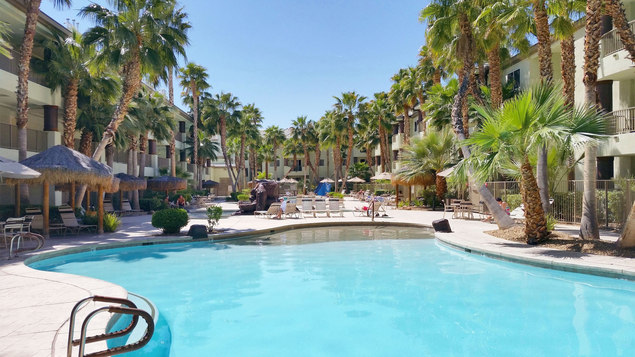 Escape to paradise at Tahiti Resort in Las Vegas, where our tropical pool oasis invites you to relax in luxury beneath swaying palm trees and lush greenery.