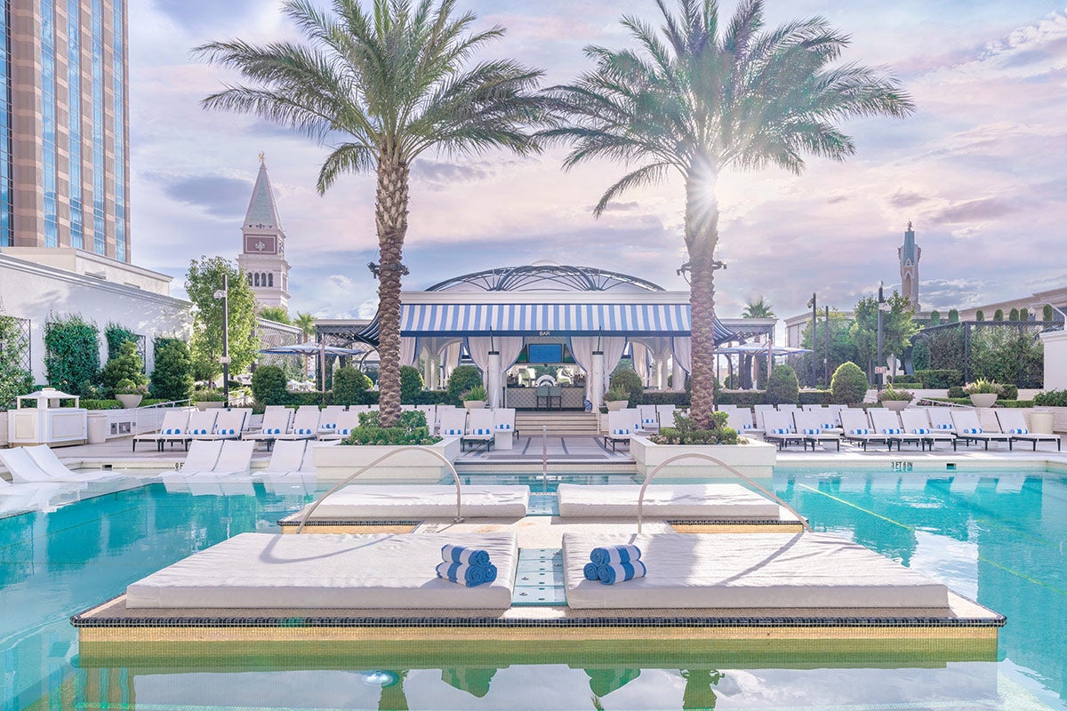 The Venetian Resort pool deck with loungers and cabanas